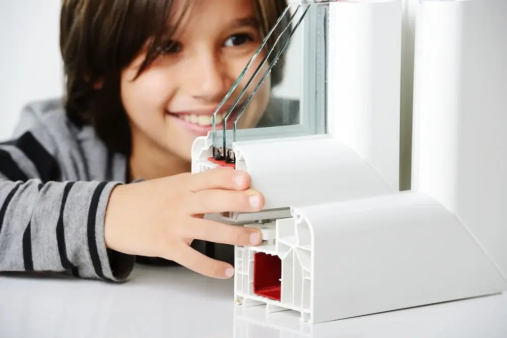 Kid holding plastic window profile