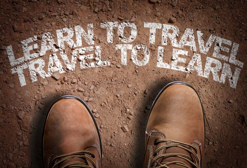 Top View of Boot on the trail with the text Learn to Travel. Travel to Learn Top View of Boot on the trail with the text Learn to Travel. Travel to Learn